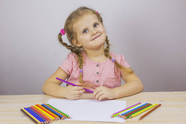 Dreaming young girl drawing with pencils - 写真・画像