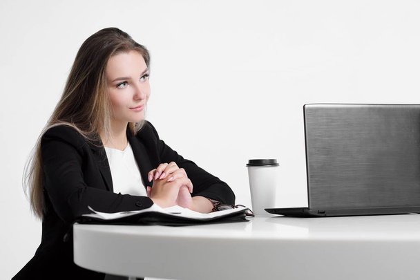Businessman girl sitting at desk in office and working on laptop on white background. - Photo, image