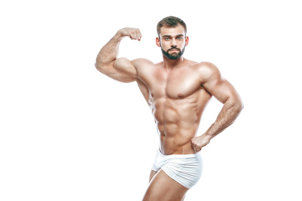 bodybuilder posing. Beautiful sporty guy male power. Fitness muscled manin white lingerie. on isolated white background. - Foto, Bild