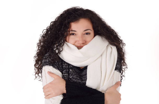 Portrait of a freezing woman in winter, wearing warm clothes. isolated on a white background. - Photo, image