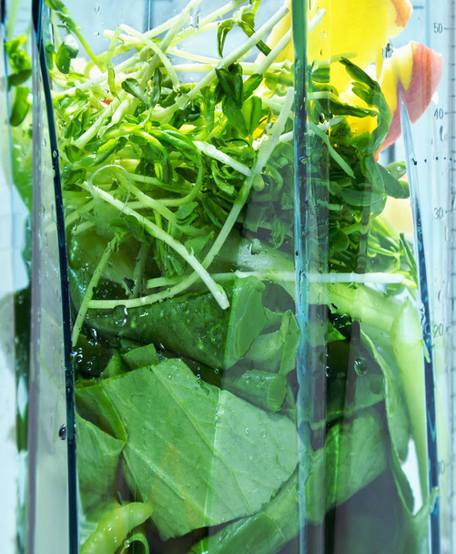 Healthy smoothie for weight loss. Ingredients for  smoothie in blender clouseup. Ingredients such as: spinach, celery, wheat germ, apple. - Photo, Image