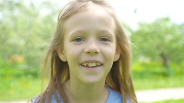 Adorable little girl in blooming apple garden on beautiful spring day - Video