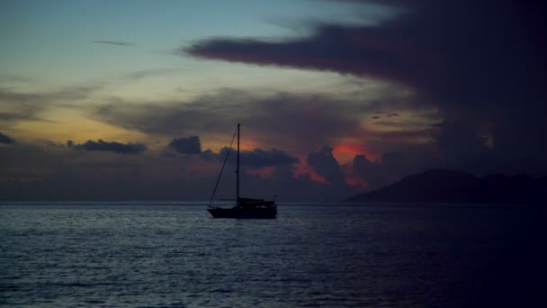 Polynesian dusk seascape view of yacht at sunset tropical Island paradise Moorea from Tahiti South Pacific ocean - Footage, Video