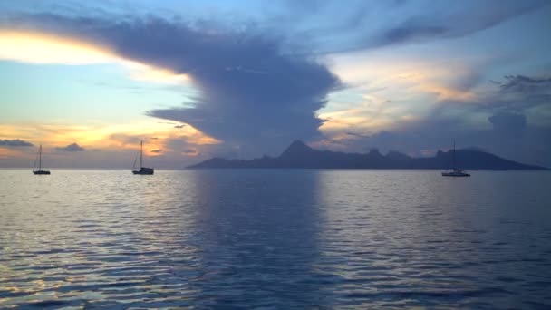 French Polynesian view of yachts anchored at sunset tropical Island paradise Moorea from Tahiti South Pacific ocean - Footage, Video