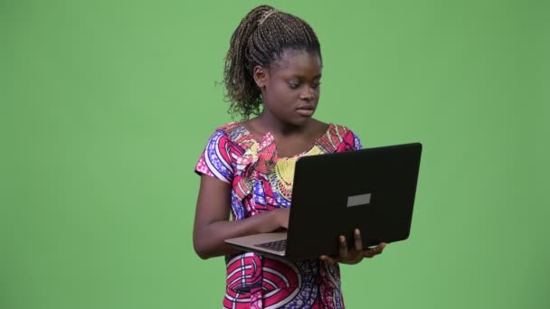Young African woman using laptop - Кадри, відео