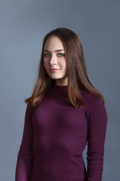 Portrait of happy nice schoolgirl teenager on gray background, studio - Fotografie, Obrázek