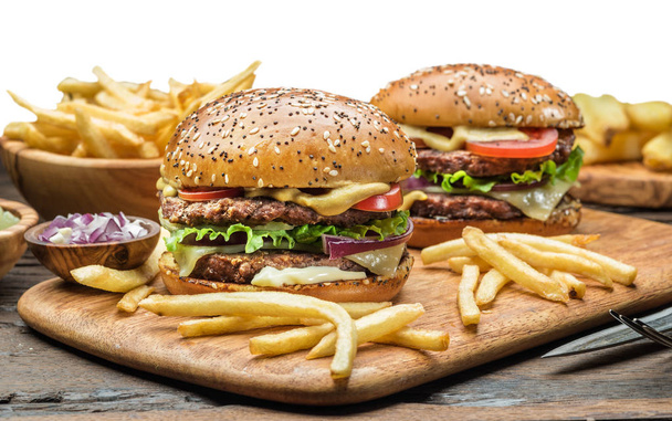 Hamburgers and French fries on the wooden tray. File contains clipping path. - 写真・画像