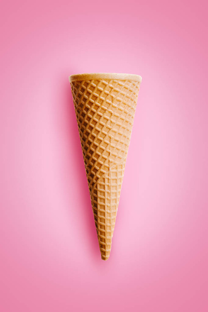 Sweet wafer cone on pink background. - Fotó, kép