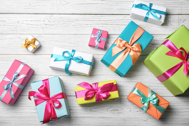 Flat lay composition with beautiful gift boxes on wooden background - Zdjęcie, obraz