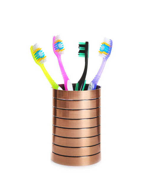 Cup with different toothbrushes on white background. Dental care - Fotoğraf, Görsel