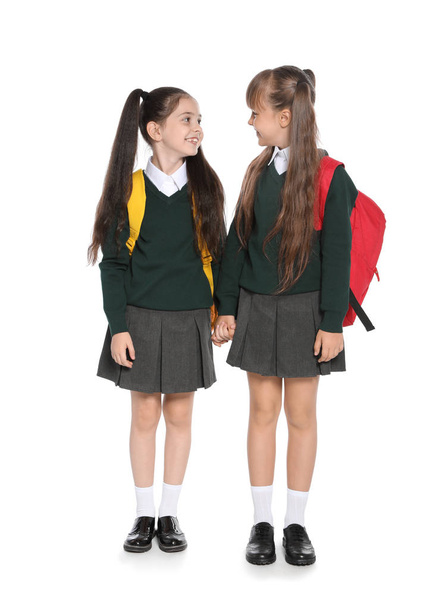 Little girls in stylish school uniform on white background - Foto, Imagem
