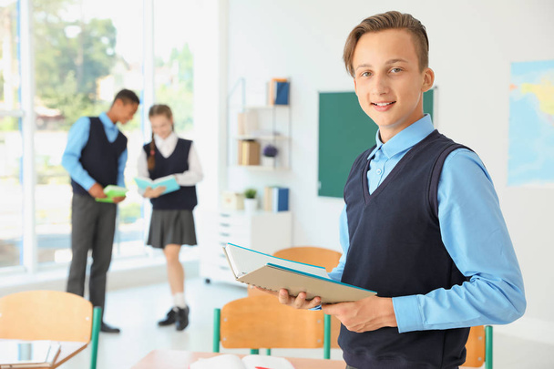 Teenage student in classroom. Stylish school uniform - Fotó, kép