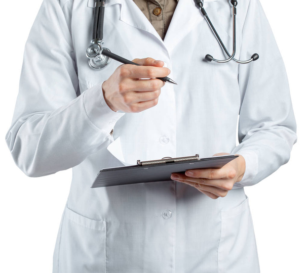 female doctor in uniform holding clipboard, close-up view - Foto, afbeelding