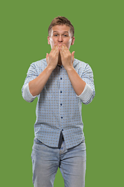 Portrait of attractive man with kiss isolated over green background - Photo, Image