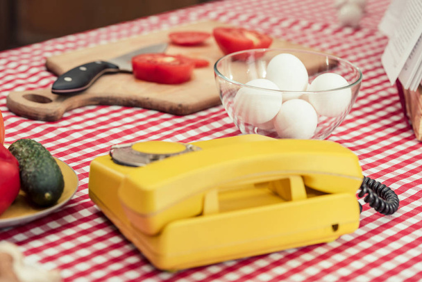close-up shot of vintage phone with various vegetables and chicken eggs on table - 写真・画像