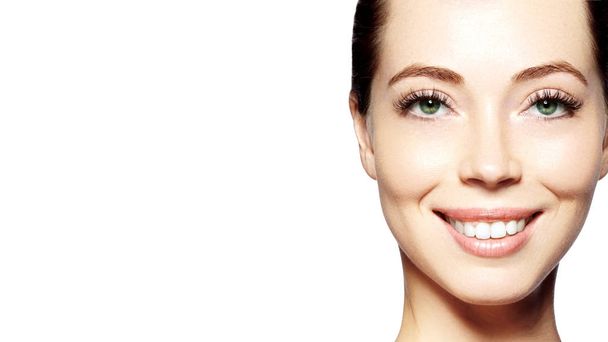 Beautiful face of young woman. Skincare, wellness, spa. Clean soft skin, healthy fresh look. Natural daily makeup. Happy smiling woman - Photo, image
