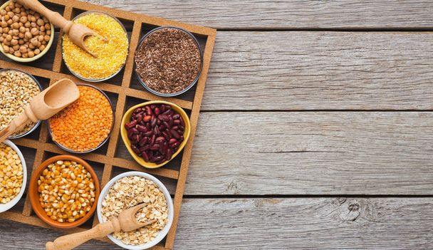 Cereals and legumes assortment on wooden table - Foto, imagen