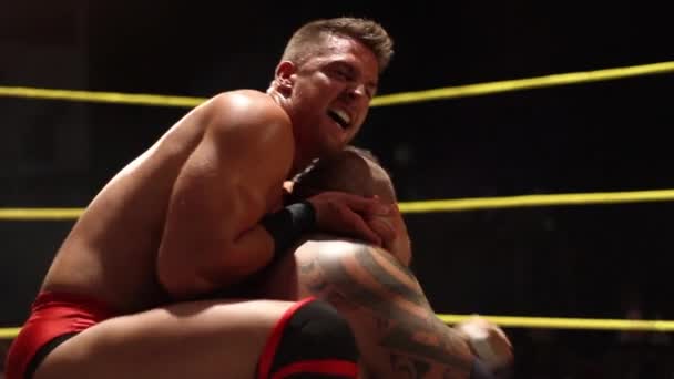 Pro Wrestling Match: Wrestler Clamps Headlock Submission Hold on Opponent - Footage, Video