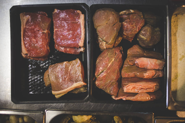Selection of uncooked steak cuts in a gourmet restaurant ready to be grilled - Fotografie, Obrázek
