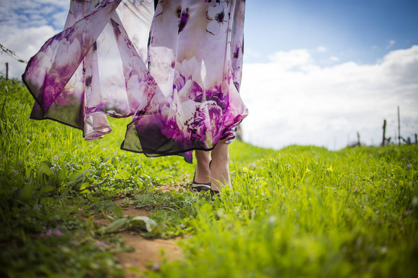 Close up image of a flower print dress blowing softly in the wind - Photo, image