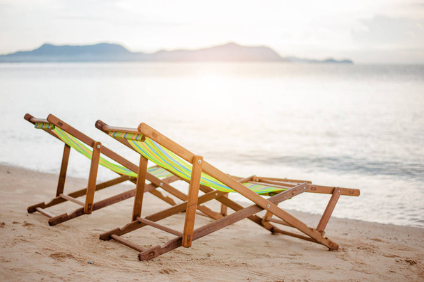Bright color wooden beach chairs on island tropical beach - Fotoğraf, Görsel