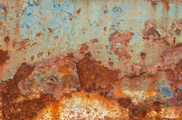 Imagen en color de un panel metálico oxidado y desgastado, apto para su uso como fondo o textura
 - Foto, Imagen