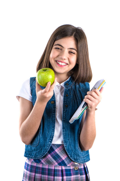 schoolgirl with notebook and apple on white background. - Φωτογραφία, εικόνα