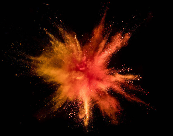 Explosion of coloured powder isolated on black background. Abstract colored background - Foto, immagini