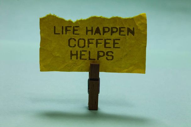 Text sign showing Life Happen Coffee Helps. Conceptual photo Have a hot drink when having problems troubles Paperclip hold torn yellow page written brown words sky blue background - Photo, Image