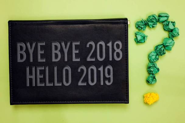 Word writing text bye bye 2018 hallo 2019. business concept for start new year motivational message 2018 is over green back black plank with text green paper lob form Question mark - Foto, Bild