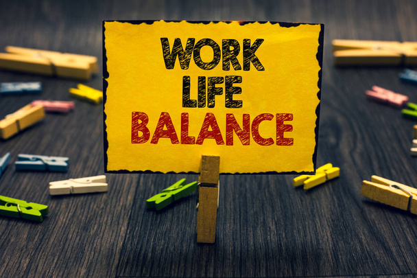 Word writing text Work Life Balance. Business concept for Division of time between working or family and leisure Blacky wooden desk laid paper clip randomly one hold yellow board with text - Photo, Image