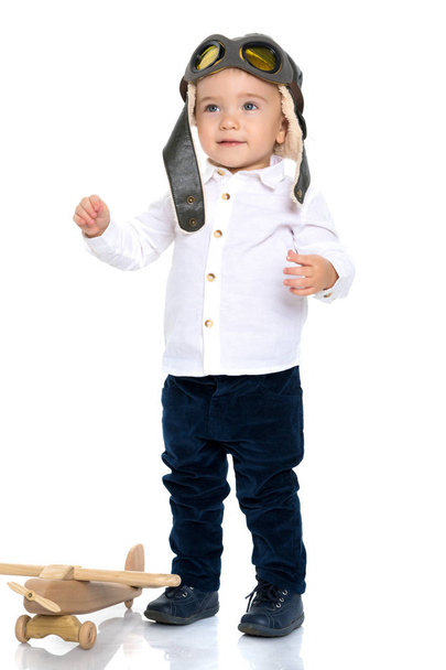 Little boy with a wooden plane. - Фото, зображення