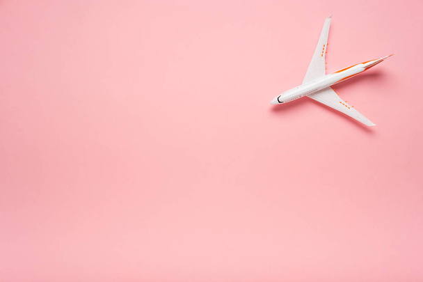 Top view of an airplane on trendy pink background.  Bright summer color. Travel concept. - Photo, image