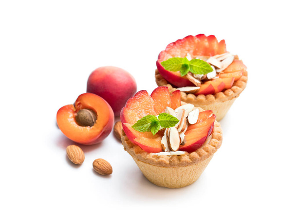 Egg custard  tarts with fresh red apricot and almonds isolated on white  - Foto, imagen