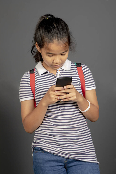 asian teenager reading message in smart phone - Photo, Image