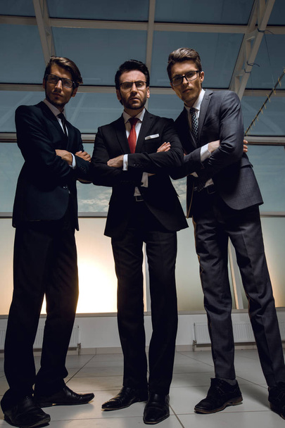 in full growth.three confident businessmen look forward - Фото, изображение