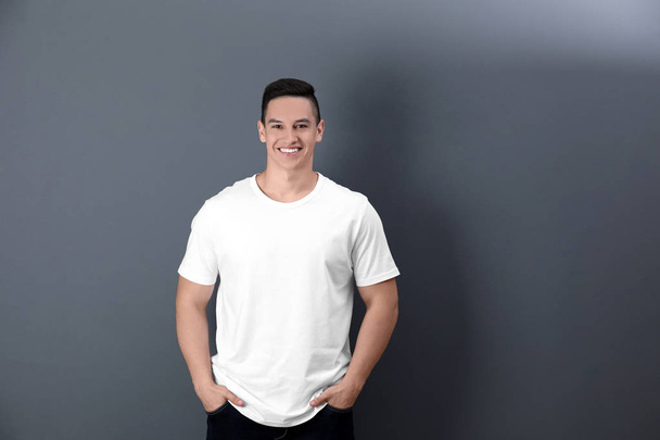 Young man in white t-shirt on color background. Mockup for design - Fotografie, Obrázek