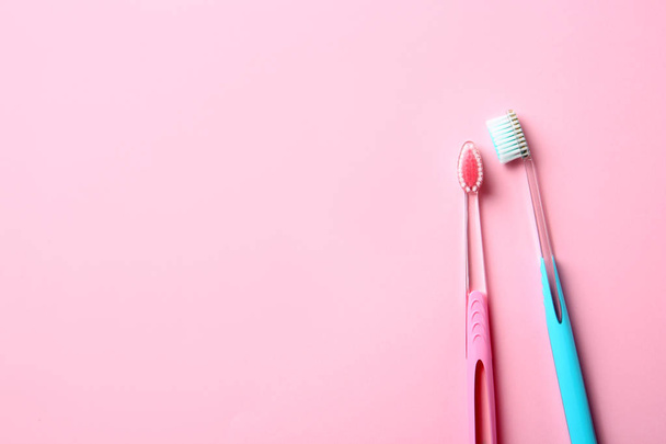 Manual toothbrushes on color background. Dental care - Foto, afbeelding