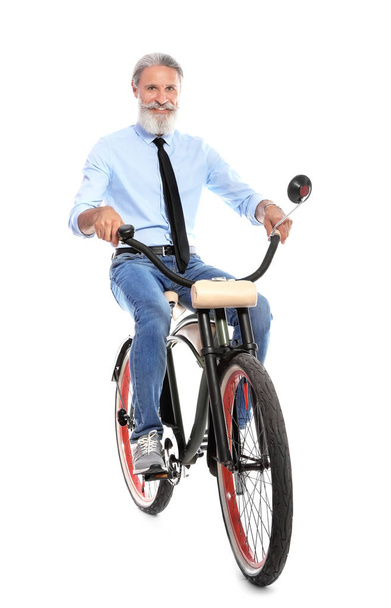 Portrait of handsome mature man with bicycle on white background - Foto, afbeelding