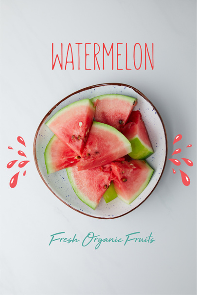 top view of fresh watermelon pieces in bowl on white tabletop, with "watermelon fresh organic fruits" lettering - Photo, Image