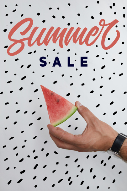 cropped shot of man holding watermelon piece in hands on white surface with summer sale lettering - Foto, Imagem
