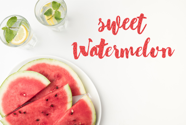 top view of watermelon slices on plate and lemonade in glasses, with sweet watermelon lettering - Foto, imagen