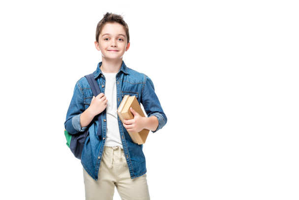 schoolboy holding backpack and books isolated on white - Fotoğraf, Görsel