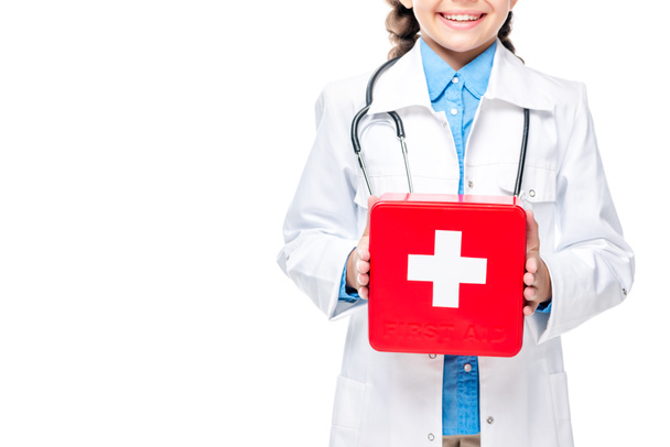cropped image of schoolchild in costume of doctor holding first aid kit isolated on white - Foto, Bild