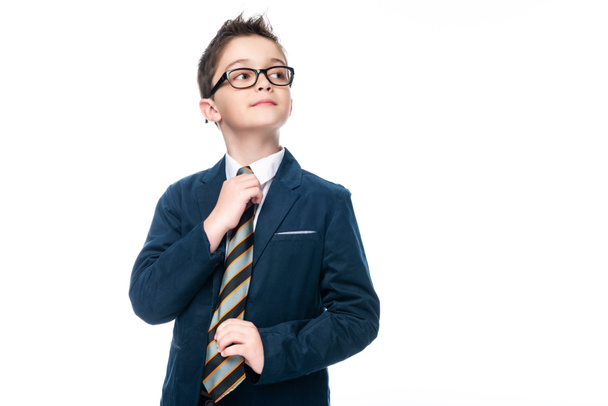 schoolboy in businessman suit tying necktie isolated on white - Foto, Bild
