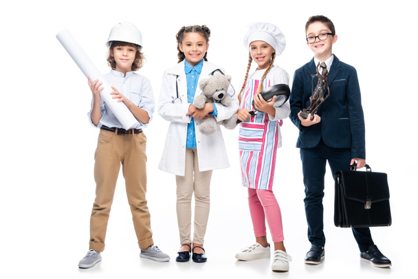 happy schoolchildren in costumes of different professions isolated on white - Photo, Image