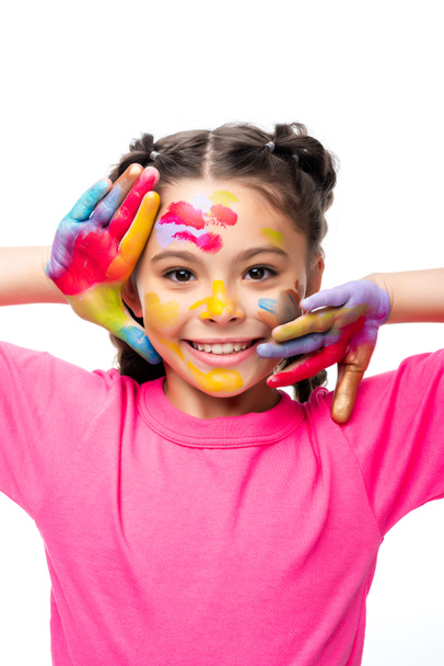 adorable écolier toucher visage avec les mains peintes isolé sur blanc
 - Photo, image