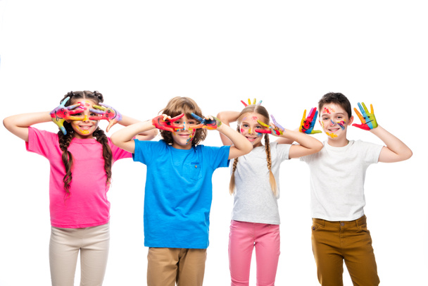 schoolchildren having fun and showing painted hands with smiley icons isolated on white - Foto, afbeelding
