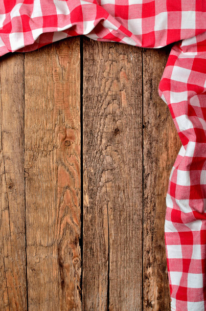 Tampo da toalha de mesa quadriculada vermelha e quadro direito no fundo da mesa de madeira vintage - vista de cima - foto vertical
 - Foto, Imagem