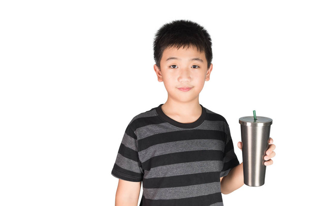 Asian kid boy holding stainless steel tumbler cup with straw, isolated on white background. - Foto, Bild
